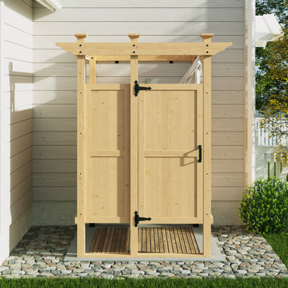 Wooden outdoor shower enclosure with a roof and doors, set against a house exterior