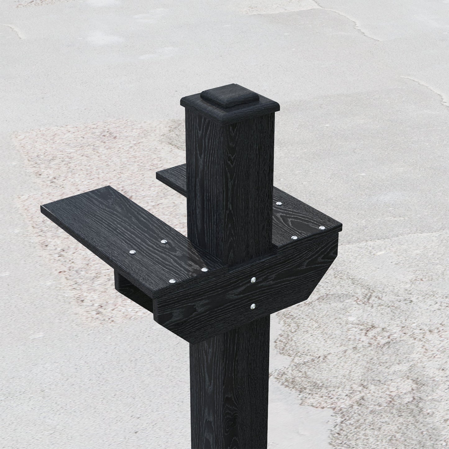 Black wooden post with steps on a gray concrete surface
