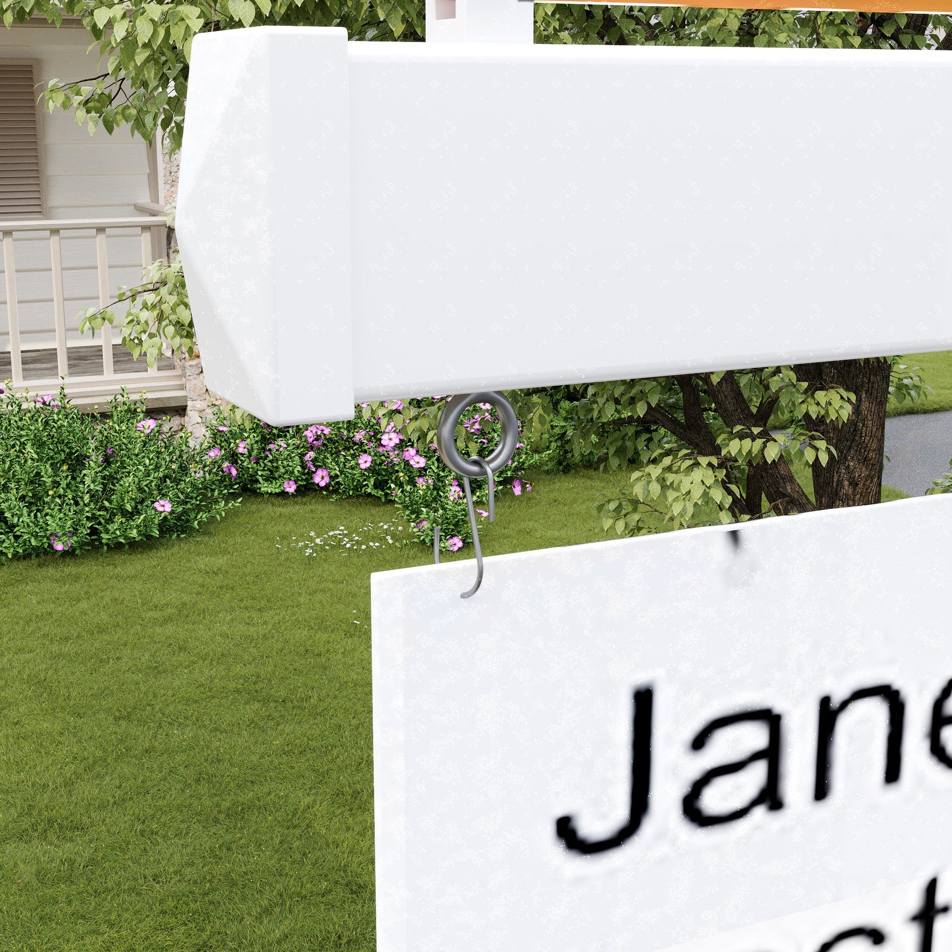 White sign with 'Jane' text attached to a garden with green grass and flowers