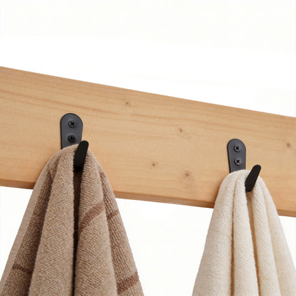 Wooden rack with black hooks holding two towels on a white background