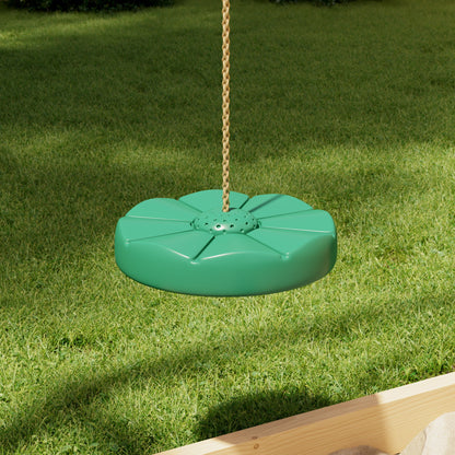 Green swing seat hanging on a chain against a grassy background