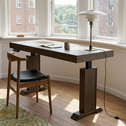Dark wood standing desk with electric height adjustment and control panel